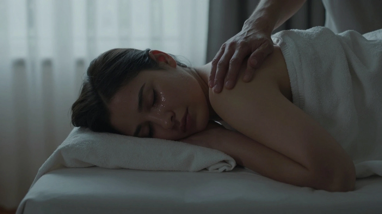 A person curled under a blanket, tear-streaked but at peace, with one hand resting gently on their shoulder in soft dawn light.